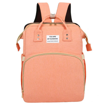 A foldable diaper bag with an insulated changing table pocket and ample storage. Mom's backpack