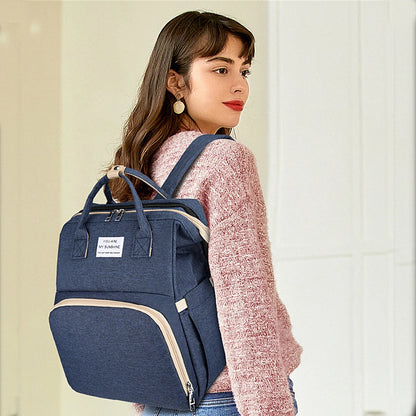 A foldable diaper bag with an insulated changing table pocket and ample storage. Mom's backpack